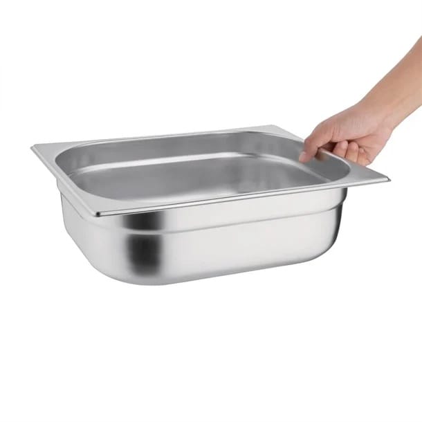 Hand holding stainless steel food service pan