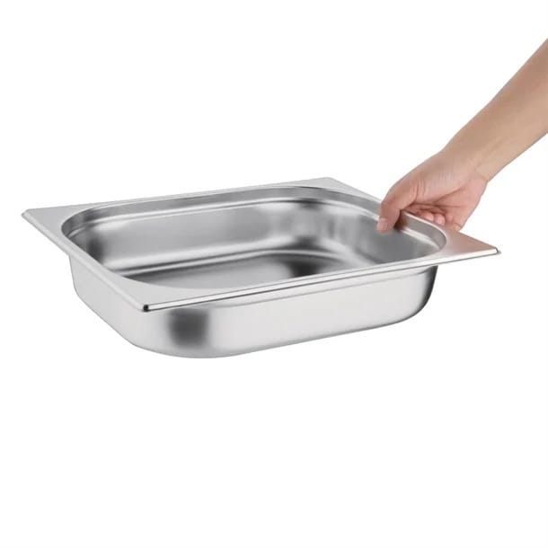 Hand holding stainless steel food pan tray