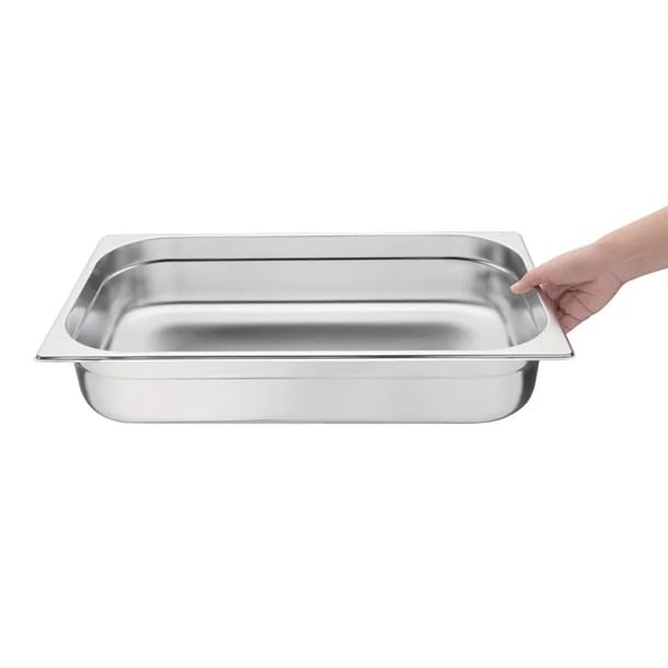 Stainless steel rectangular food pan held by hand